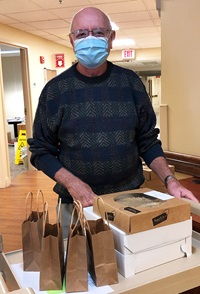 Volunteer Ray picking up pies